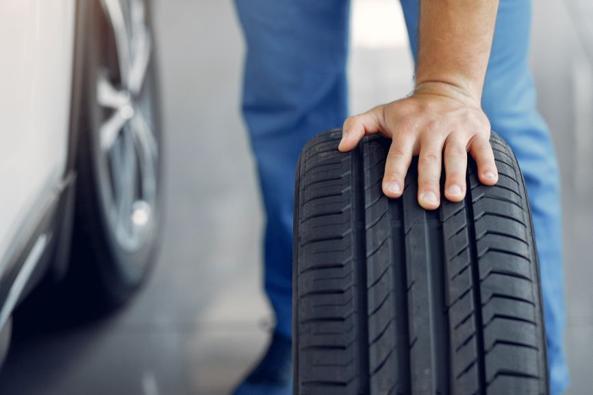 a mechanic checks the tread on mid range tyres