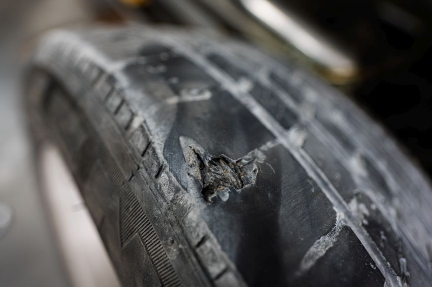 Severe cracking across the tread and sidewall of a worn tyre